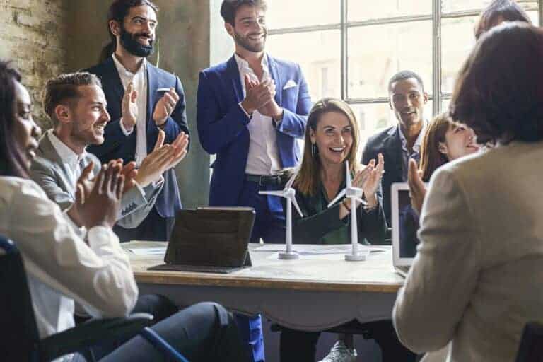 Group of multiethnic coworkers applauding the success of a sustainable project